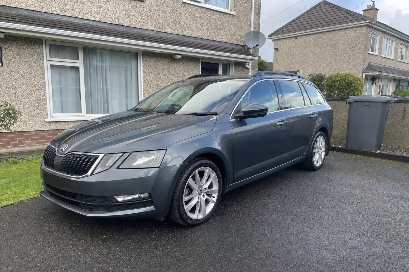 a detailed estate car on a driveway after detailing
